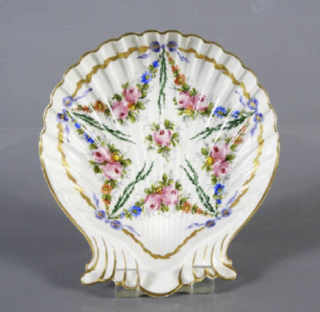 CP MEHUN PARIS SHELL SHAPED DISH: A hand-painted serving dish, the shell shaped hand-painted dish decorated with garlands, pink and blue flowers, gilt trim, marked "Decore Main Paris CP Mehun", French, 2 x 9 inches. 2 x 9 inches.