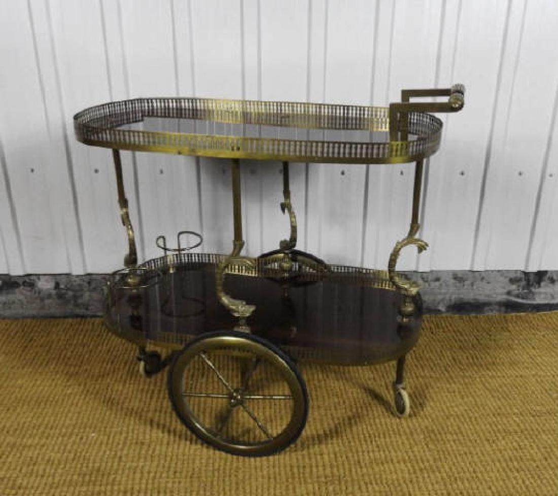 VINTAGE FRENCH BRASS & MAHOGANY DRINKS CART: Vintage French brass and mahogany drinks cart, two-tier with pierced and shaped galleries, the supports detailed with figural dolphins, 25" x 29" x 16".