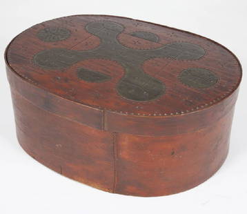 MI'KMAQ BOX / BOÎTE MICMAQUE: A red painted Mi'kmaq oval box with traditional central four-lobed motif in black (oxidized dark green) paint with two compass pinwheels, half-circles and chip carved borders. Lunenburg, Nova