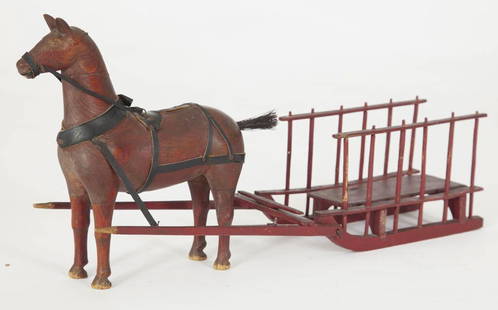 HORSE & SLEIGH TOY / JOUET CHEVAL & TRAÎNEAU: A finely executed horse and sleigh child's toy in original red paint. Quebec, circa 1900. H: 8"; L: 17". // Un cheval et traîneau, couleur d’origine, bien exécutés.