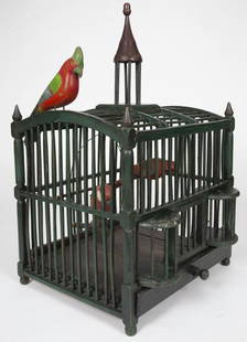 WOODEN BIRD CAGE / CAGE À OISEAUX EN BOIS: A wooden bird cage in dark green paint with ball feet, turned finials and a cupola with red painted roof. 19th century. Illustrated: Celebrating Canada, page 111. Bird sold separately (Lot #23). 