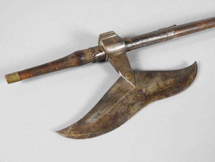 LATE 18TH CENTURY INDIAN BATTLE AXE: A good late 18th century Bhil form Indian battle axe fitted with a bronze concave blade (9.75") and square hammer finial. Shaped wooden handle. Overall length, 35.5".