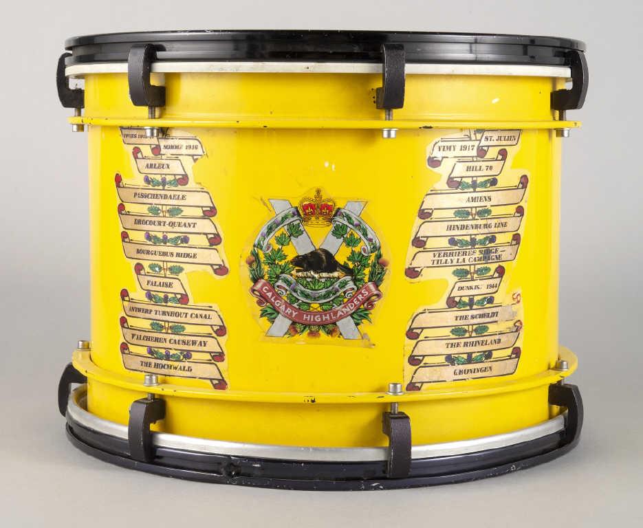 CALGARY HIGHLANDERS REGIMENTAL DRUM: A Calgary Highlanders regimental drum. The drum, painted in regimental yellow, decorated with a list of 20 battles the regiment has been involved in since the First World War. Diameter, 16.5".