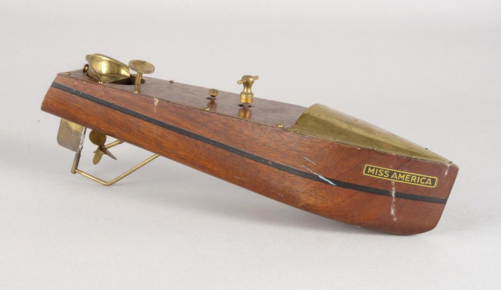 MISS AMERICA WOODEN POND BOAT, CIRCA 1930: Miss America wooden pond boat by "Mengel Playthings", retaining original mahogany finish, brass accents and knobs, hull screws and decals. Circa 1930. Dimensions, 3.625" x 3.75" x 14.5".
