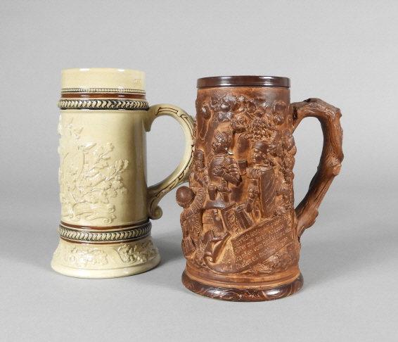 KAISER & TAVERN RELIEF GERMAN STEINS: Two German steins. (1) "Kaiser" stein for unit 142 marked "DRGM 100131" (Deutsches Reiches Gebrauchs Musterschutz). (2) Stein with relief medieval tavern scene, in a brown glaze, marked Germany. Talle