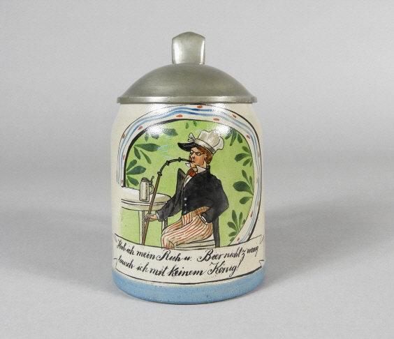 GERMAN STEIN, MARKED 1810: A German stein, hand-decorated with a charming scene of a man smoking a long pipe and drinking beer. The caption roughly translates "I have my rest, I don't share beer with anyone". Marked 1810 on bot