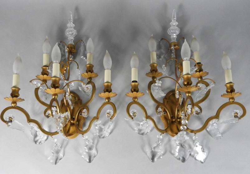 PAIR OF GILT PATINATED FIVE-LIGHT SCONCES: Pair of mid 20th century gilt patinated five light wall sconces hung with prisms. Height, 21.5".