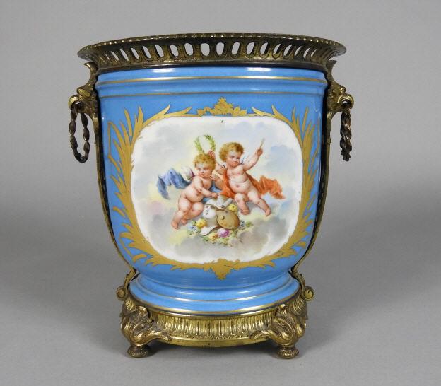 FRENCH PORCELAIN CACHE POT, LATE 19TH CENTURY: A late 19th century French porcelain cache pot / wine cooler, the bleu celeste body decorated with hand painted romantic vignettes, fitted with a pierced ormolu rim with handles and a rocaille ormolu 