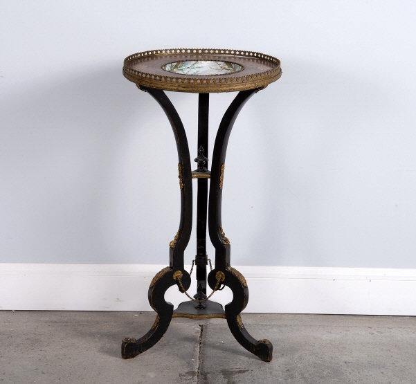 NAPOLEON III PERIOD GUERIDON, CIRCA 1875: A late 19th century Napoleon III period part ebonized gueridon, the top showing a hand painted porcelain bowl decorated with songbirds set within an amboyna border inlaid with foliate motifs, raised o