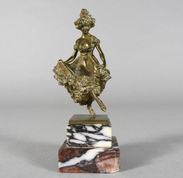 ART - Carl KAUBA (1865-1922, Austrian): A very good gilt bronze figure of a Cancan dancer by Carl Kauba, signed on base and raised upon a two-tiered mottled marble base. Overall height, 5.25". Height of figure, 4".