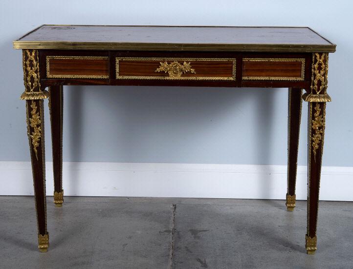 LOUIS XVI STYLE MAHOGANY MARQUETRY HALL TABLE: A good 20th century mahogany and marquetry hall table in the Louis XVI style, the top showing chevron and cross banded inlays within a brass moulded edge, the frieze decorated with ormolu mounts and f