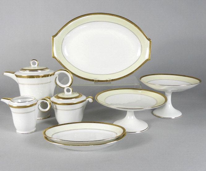 LARCHEVEQUE UML LIMOGES PORCELAIN TABLEWARE: A 20th century Larcheveque UML Limoges porcelain part dinner service decorated with chevron motifs against a gilt border, consisting of the following: 33 dinner plates, 12 soup plates, 12 salad plates
