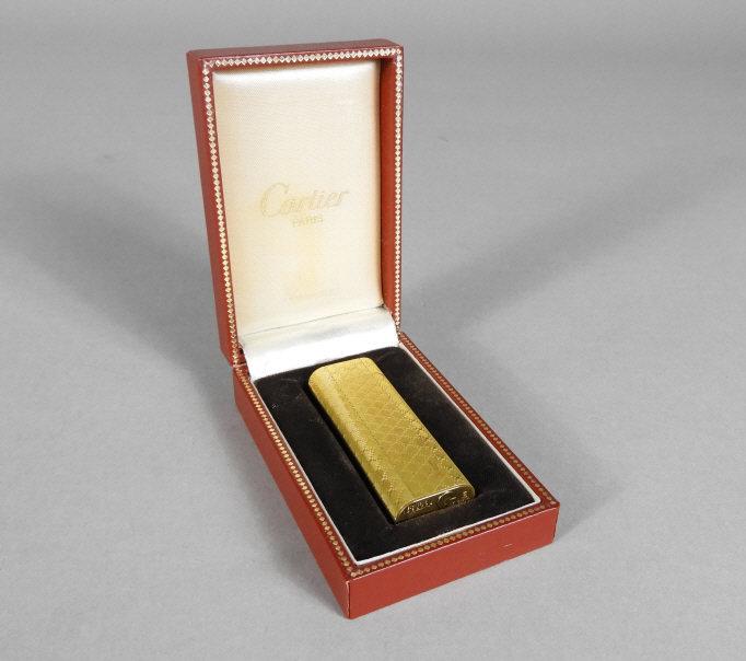 CARTIER GOLD PLATED LIGHTER: A very good mid 20th century Cartier gold plated cigarette lighter, set within its original satin and velvet lined presentation case.