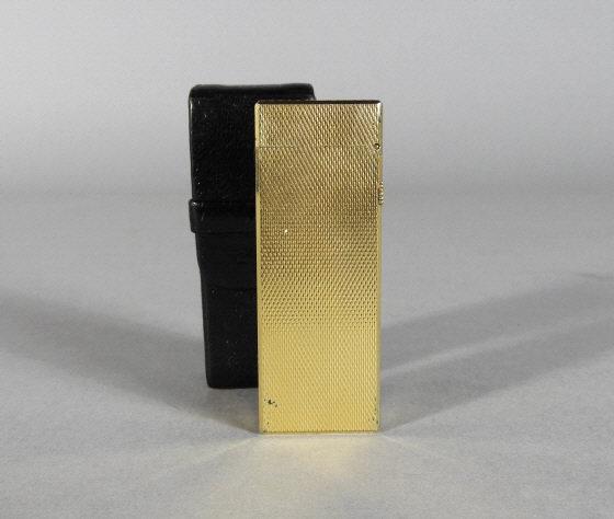 VINTAGE GOLD PLATED DUNHILL LIGHTER: A vintage gold plated Dunhill lighter with original black leather case. Marked made in Switzerland on the lighter and 'Dunhill' on the case.