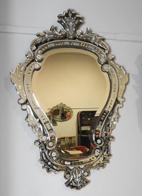 VENETIAN STYLE GLASS WALL MIRROR: A 20th century Venetian style glass wall mirror, the cartouche shaped frame decorated with hand applied scrolling segments accented with frosted detail. Dimensions, 38" x 26".