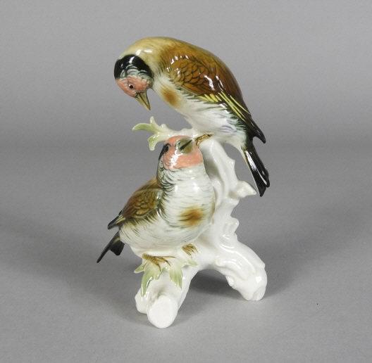 EAST GERMANY PORCELAIN BIRDS: A 20th century hand painted east German porcelain grouping of 2 lovebirds on a naturalistically modelled base. Factory marks on underside of base. Height, 6".