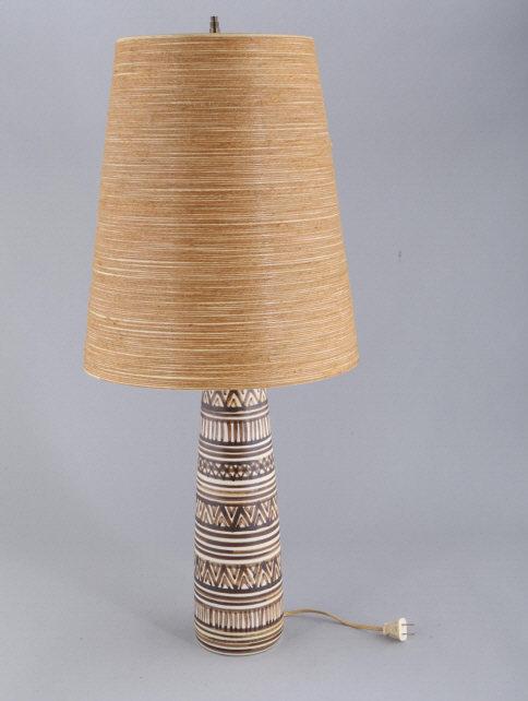LOTTE MID CENTURY MODERN TABLE LAMP: Canadian Lotte table lamp decorated and signed by Lotte at the base. Overall height, 33", ceramic only 18" h x 4.75" diameter. Shade 16.5" h x 14" diameter. Gunnar and Lotte emigrated to Canada from D