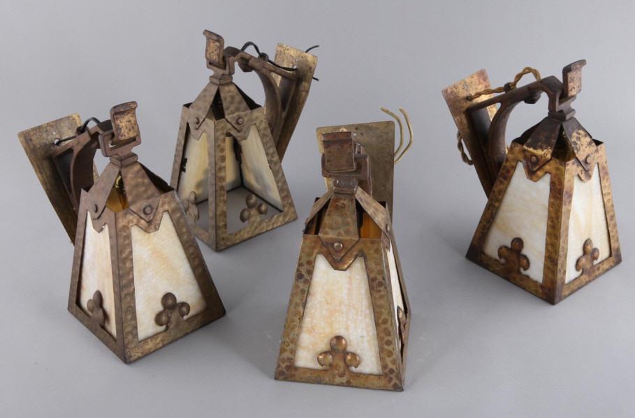 ARTS & CRAFTS HANGING LIGHT FIXTURES: A set of four Arts and Crafts hammered metal hanging light fixtures with caramel slag glass panels. Dimensions, 12" h x shade 6" diameter x 10" from the wall.