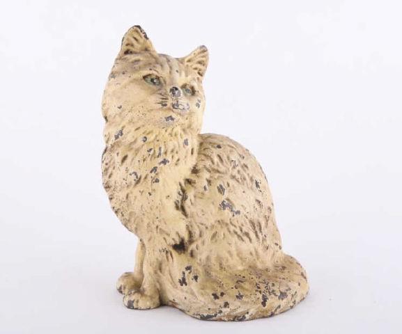 Cast Iron Cat Doorstop: A Hubley cast-iron doorstop in the form of a cat with green eyes, old white paint, Pennsylvania, early 20th century. H: 8.5"; W: 6"; D: 5.5". Collection: Leask.