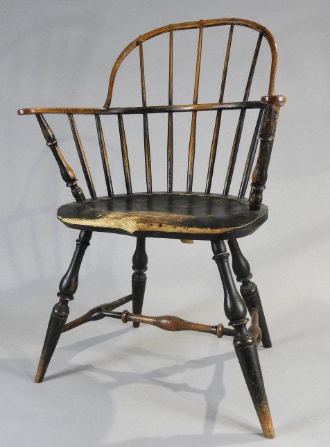 Sackback Windsor Armchair, American, 18th Century: A sackback Windsor armchair with pine seat in dark green original paint. Legs are mortised through the seat which has a strongly defined gutter and shaped pommel at the front. Crisp vase and ring turn