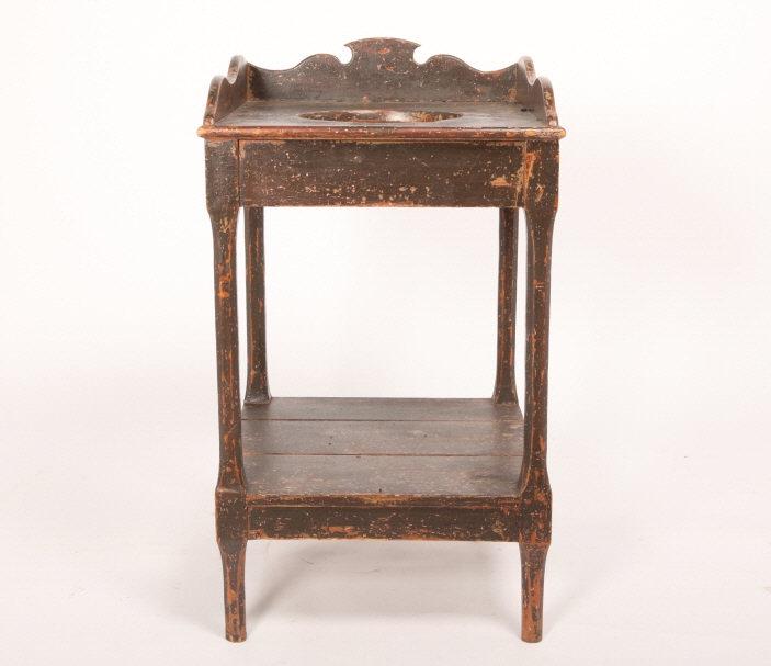 Pine Washstand, Québec, Circa 1850: A pine washstand with shaped gallery and chamfered legs with a lower shelf, all in original brown paint, no repairs. Hole in top for wash basin. Circa 1850, Quebec. H: 31"; W: 18"; D: 18". Collection: