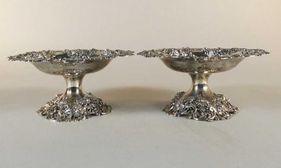 Pair of Sterling Silver Tazzas: A very good pair of sterling silver tazzas, both showing foliate cast and pierced bodies raised upon similarly stylized bases. One marked STERLING on the underside of the base, both bearing model numb
