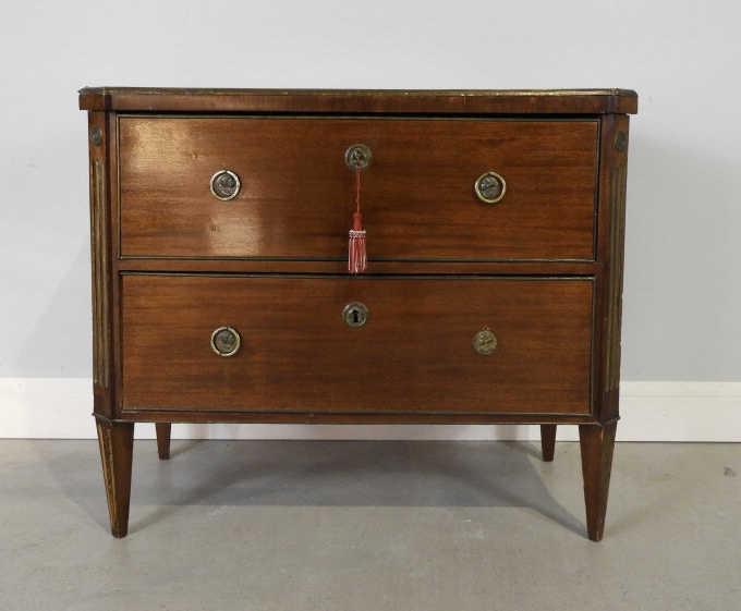 Two Drawer Mahogany Commode, Sweden, Ca. 1800: A 19th century Gustavian brass inlaid 2 drawer commode in mahogany, showing a brass bound top with canted corners, over 2 full width drawers with original brasses and locks, raised overall on tapering