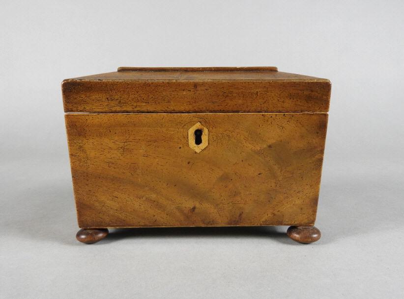 Mahogany Sarcophagus Shaped Tea Caddy, 19th C.: A small 19th century sarcophagus shaped mahogany tea caddy, the lid opening to an interior fitted with twin lidded tea compartments, and retaining its ordinal lock mechanism. Raised overall on 4 compr