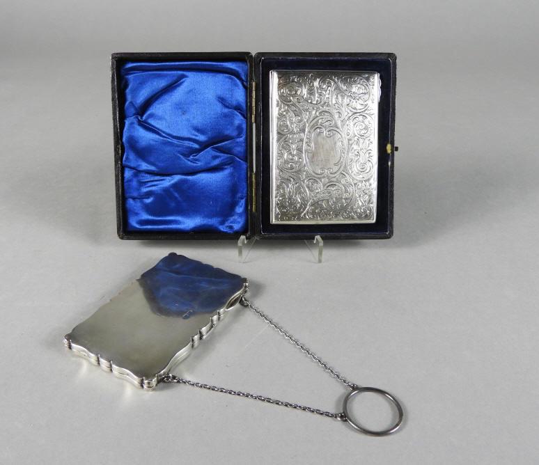English Hallmarked Silver Calling Card Cases: Two English sterling silver ladies calling card cases, one engraved with foliate and scrolled motifs, and a blank cartouche, opening to a fitted interior (distressed) with an 'aide memoire' celluloid 