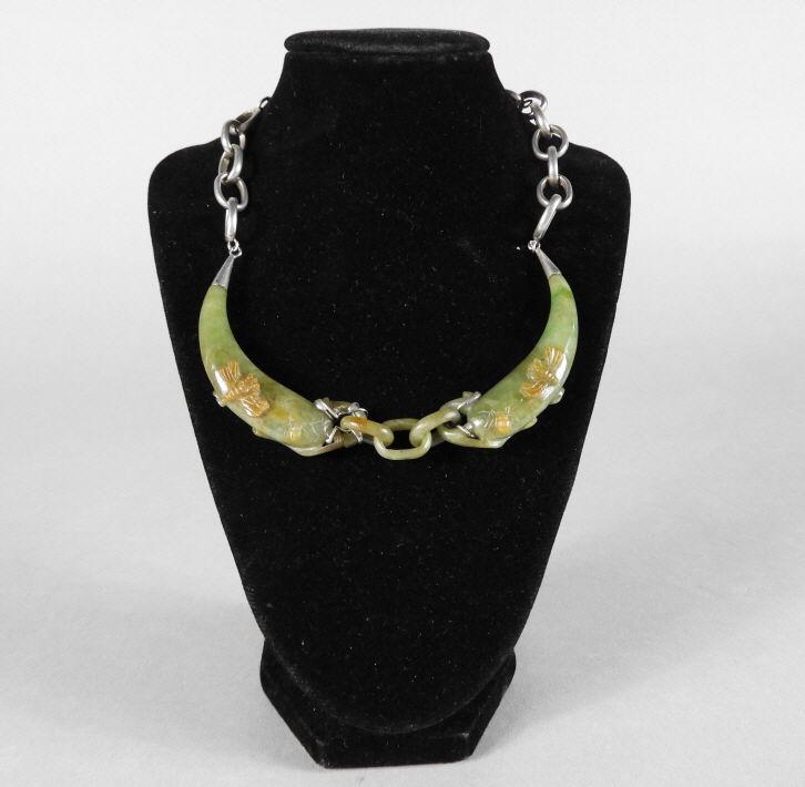 Chinese Jadeite Pepper-Form Necklace: A Chinese jadeite pepper-form necklace, the mounted jade pieces carved with insects in relief, fitted with a silver chain. Early 20th Century. Condition: repaired-reinforced to the ends of both pieces