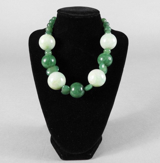 Chinese White & Green Jadeite Necklace: A Chinese white and green jadeite necklace decorated with alternating light and dark green jade balls. Mid 20th Century. Possibly re-strung. Provenance: The Estate of Eva Gauthier, Ottawa. Note: Ida J