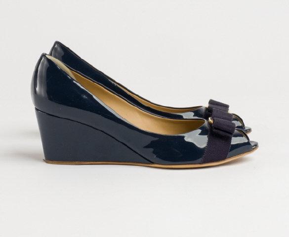 Salvatore Ferragamo Shoes: A pair of Salvatore Ferragamo wedge shoes in navy blue patent leather and gold buckle, size 7.5.