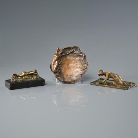 Three Art Nouveau Bronze Desk Accessories: Three Art Nouveau bronze dresser accessories, one with a nude lying on her front on a bed of foliage & mounted on black marble base, one gazing into a pond and a vide-poche with a dancing maiden. Larg