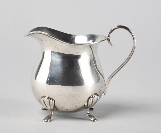 Hallmarked Silver Creamer: A hallmarked silver creamer, marks for Birmingham, raised on pad feet, maker’s marks and date mark rubbed, circa 1900, weight: 118 grams.