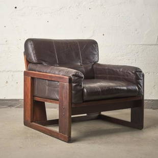 MCM HARDWOOD FRAMED LEATHER CLUB CHAIR: Circa 1970, the open hardwood frame upholstered with dark brown leather armrests, seat & back, measuring 30" high x 39" deep x 29" wide.