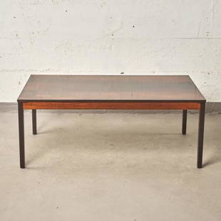 MCM DANISH HARDWOOD COFFEE TABLE: Denmark circa 1970, the figured rectangular top raised on four squared supports, measuring 20" high x 50.25" wide x 28.5" deep.