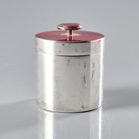 DAVID ANDERSON ENAMELLED STERLING CANISTER: Norway, circa 1960, the cylindrical sterling silver base fitted with a red guilloché enamelled lid rising to an enamelled knop, the underside of the base bearing impressed factory marks, sterling