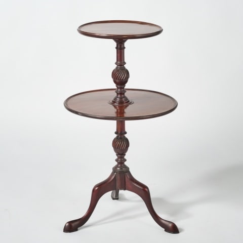 DIMINUTIVE TWO TIERED MAHOGANY DUMBWAITER: British, circa 1790, showing two graduated dished circular shelves spaced by flute carved vase-shaped columns, raised overall on a trio of cabriole supports terminating to snake feet, minor repairs to