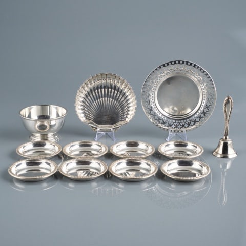 20TH C. BIRKS STERLING TABLE ACCESSORIES: Canada, circa 1940, consisting of eight circular coasters / nut dishes, a small pierced dish measuring 5.75" diameter, a small footed bowl measuring 2.25" high x 3.75" diameter, a small shell shaped d