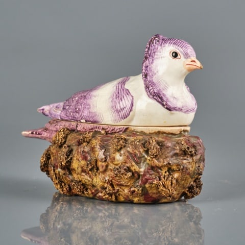 RARE STAFFORDSHIRE POTTERY DOVE-ON-NEST: England circa 1820, a well modelled tureen / game dish in the form of a dove decorated in purple lustre, nestled atop a shredded clay decorated nest-shaped base, minor areas of paint loss. Measuring 4