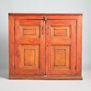 CANADIAN RED STAINED PINE JAM CUPBOARD: Canada circa 1870, the case showing a pair of panelled cupboard doors retaining what appear to be original hardware, opening to a shelved interior and raised overall on a plinth base, the vertical pan