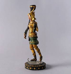 COLD PAINTED FIGURE OF A GUARD: A cold painted spelter figure of a lanterneer holding a rush lantern and wearing skates, height 14.5 inches.