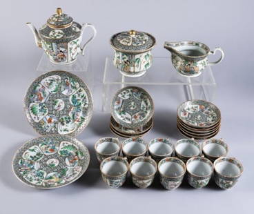 CHINESE LATE REPUBLIC PERIOD TEA SET: Consisting of two luncheon plates (8" dia.), a teapot (7" high), milk, sugar, ten cups and saucers, all decorated with enameled panels of court and garden scenes.