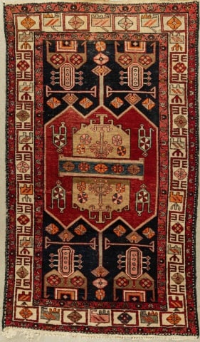 SEMI-ANTIQUE ANATOLIAN TURKISH RUG: Circa 1960, the cobalt field centred by a cranberry lozenge with tan elements, within a cream border with geometric motifs, measuring 90" x 54". This rug may have wear and tear, imperfections, commens