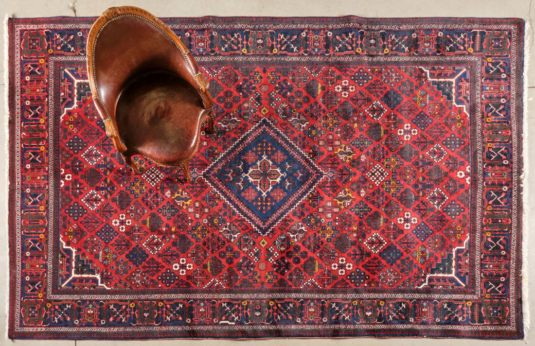 PERSIAN MEMEH CARPET: Late 20th century, showing diagonally arranged diamond-shaped motifs of flower heads and fruiting trees in shades of white, yellow and navy, against a reddish field centred by a navy diamond shaped me