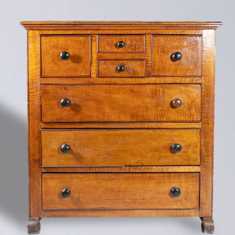 CANADIAN CHEST OF DRAWERS: The chest of drawers in butternut and tiger maple. Interesting drawer arrangement. Beaded drawer openings. Drawer pulls intact. Back gallery board missing. Circa 1870. 51 1/2" H, 44 1/2" W, 22 1/2" D.
