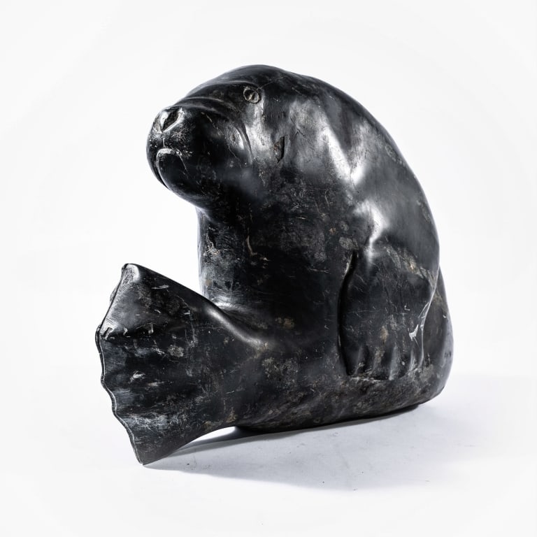 QAQAP ASHOONA (1928-1996): Qaqaq (KAKA) Ashoona (1928-1996) Ikerrasaak Camp, South Baffin Island, a large and early dark green stone carving of a seal or walrus, signed KAKA to the base. Kaka's mother was the world famous