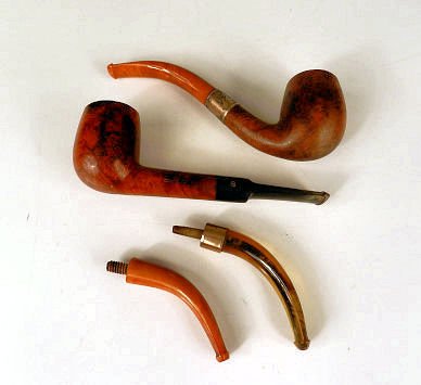 Smoking paraphernalia: Two smoking pipes; one with Bakelite stem & hallmarked sterling silver ring (condition to stem), a Simpson's pipe & two pipe tips