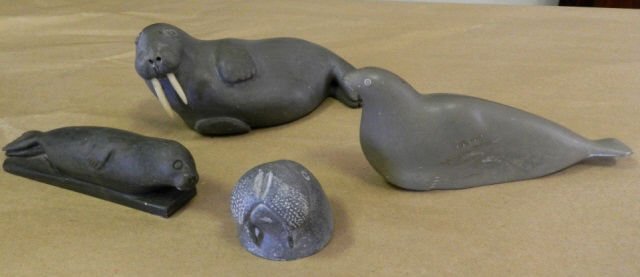 Art Inuit carvings: Assembled group of 4 Inuit stone seal carvings, 1 chip to tail and other minor chips