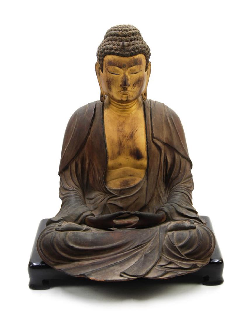 A JAPANESE CARVED GILT WOOD SEATED BUDDHA, EDO DYNASTY: A gilt wood figure of Buddha Seated in dhyana. H: 10in ( 25.4 cm) W:8in ( 20.3 cm)